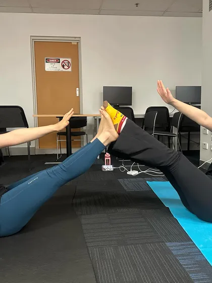 This partner boat pose (Navasana) is a playful way to engage the core and build strength together. Laughter and smiles are always a welcome part of my yoga sessions.