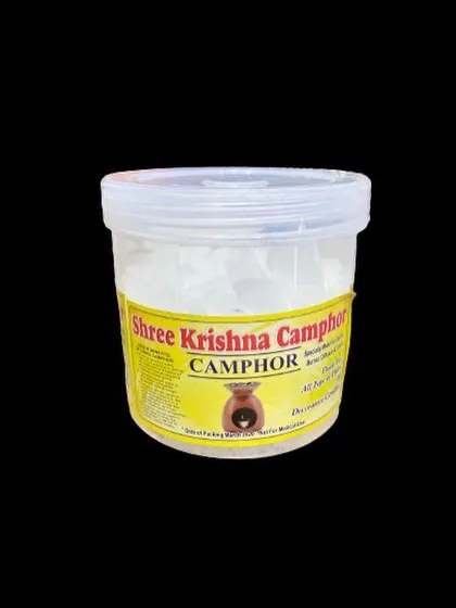 Our Shree Krishna Camphor comes in a securely sealed tub to maintain its freshness and strong, purifying scent. This image shows the product against a clean black background, highlighting the pure camphor crystals inside.