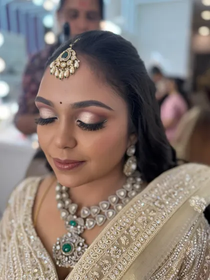 A close-up of Prithivi's reception makeup with her eyes closed. The look features a dramatic double-winged liner and a shimmery, light-toned eyeshadow.