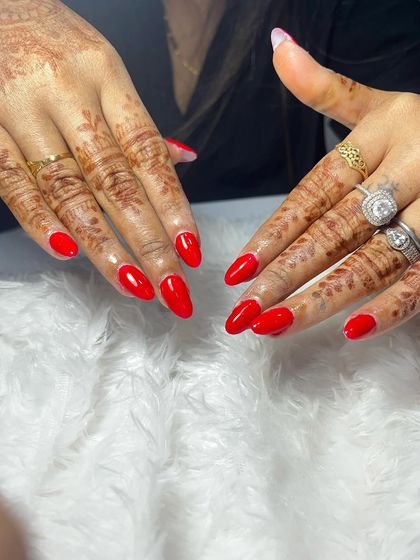 A classic and bold choice for any celebration. Here, I applied acrylic extensions to add length and shape, then finished with a vibrant, glossy red gel polish that looks stunning against the mehndi.