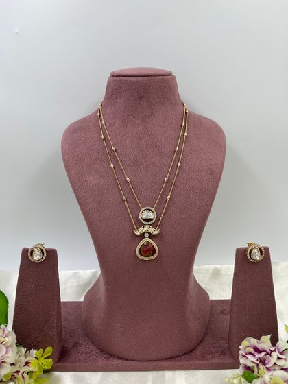 The Myra Crystal Bloom Necklace. This is another lightweight, double-chain design with crystal pendants, perfect for modern and minimalist tastes. Available in red and green.