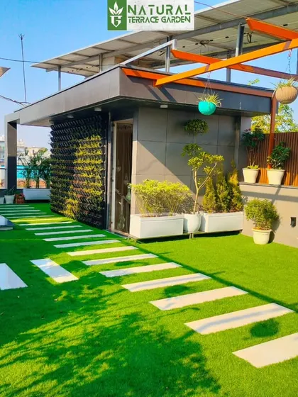 This angle shows the pergola's placement on the terrace, with solar panels visible on the roof above, demonstrating how we work with existing structures.