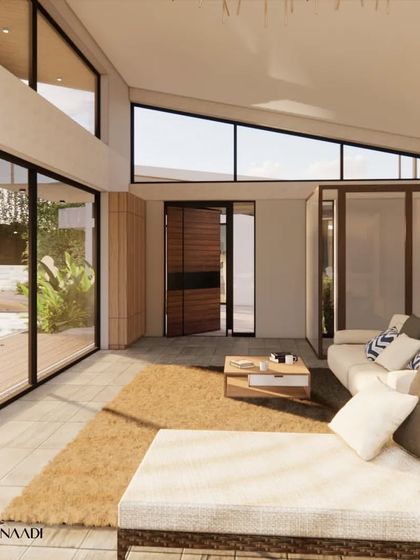 The living area of the waterfront home is a light-filled, open space. The sloped roof with clerestory windows allows northern light to fill the interior, while large glass panels frame views of the central courtyard and the river beyond.