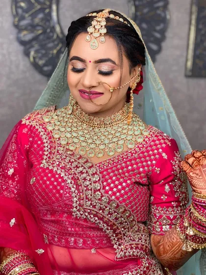 A close-up of the same bride, with her eyes closed to showcase the beautiful glittery eye makeup.