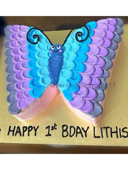 A pretty butterfly-shaped cake for a first birthday. I use buttercream piping techniques to create the colorful and textured wings.
