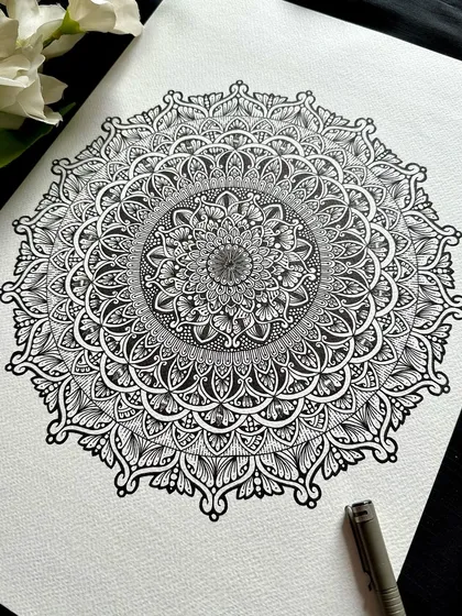 There is a timeless elegance to classic black and white. This large A3 mandala showcases the beauty of intricate linework and detailed patterns, creating a sophisticated and meditative piece that adds a touch of 'Saadgi' or simplicity to your decor.