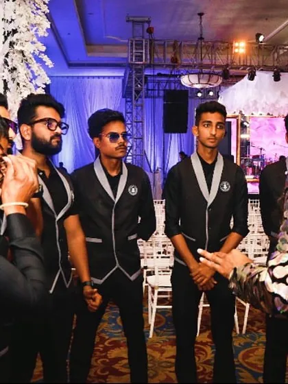 Final instructions before go-time. My team is focused and ready to shake things up for the reception party.