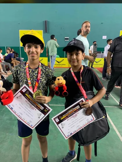 The smiles of champions. Here are two of my dedicated students proudly showing their medals and certificates after their success at the Delhi State badminton tournament. Their achievements are my greatest reward.