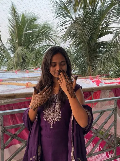 A candid moment, smelling the beautiful fragrance of the fresh henna.
