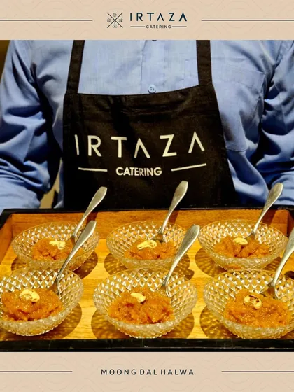 My classic Moong Dal Halwa, a rich and comforting Indian dessert. Here it is being served by my staff in beautiful crystal bowls, showcasing my commitment to quality service and presentation.
