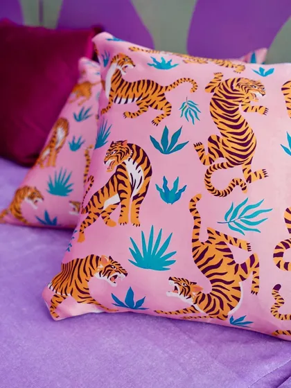 A close-up of a custom-printed cushion with a tiger pattern, adding a bold and trendy touch to the tropical-themed seating.