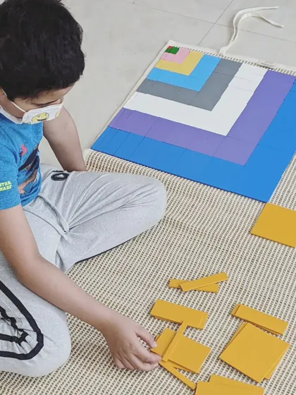 The Montessori approach makes abstract concepts concrete and beautiful. This student is exploring the decanomial square, a sensorial material that lays the foundation for understanding multiplication and geometry. Our diploma course dives deep into the genius of these math materials.