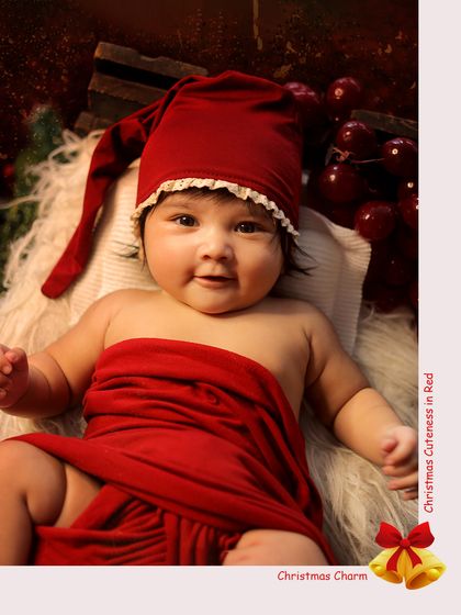 Christmas cuteness in red. This adorable baby looks right at the camera, showing off her festive hat and chubby cheeks.
