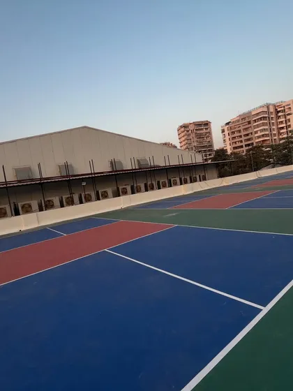 This angled shot showcases the expanse of the playing area. The vibrant blue and green court colors are designed for high visibility of the ball during fast-paced games.