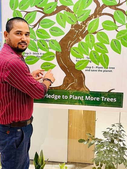 Our Green Warriors were out in full force for Van Mahotsav. Here, a participant points to his pledge, ready to take home a sapling and start his green journey.