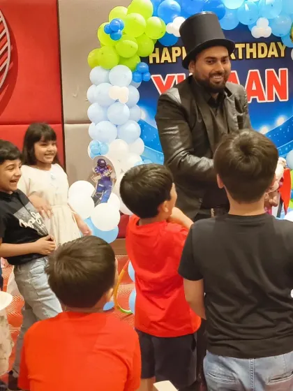 It's not just about the decor, it's about the joy. Here, a magician captivates his young audience at a cricket-themed birthday party we managed. We arrange top-tier entertainers to ensure every guest has a fantastic time.