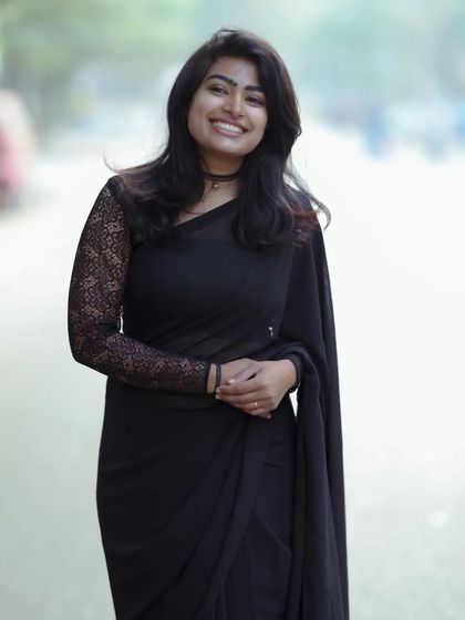 A smiling version of the black saree look. The makeup is versatile enough for both serious and joyful expressions.