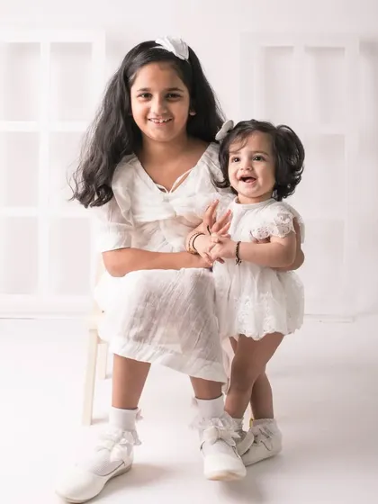 A candid moment of laughter between two sisters. Their genuine joy is what makes this photo so special.