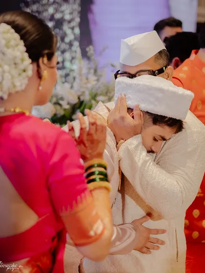 An emotional hug between the groom and a family member during the ceremony.
