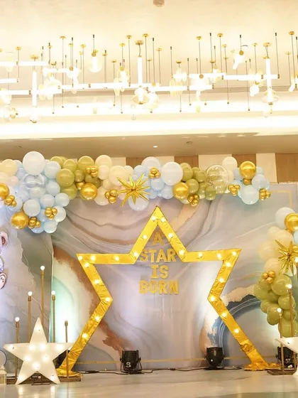 For this cradle ceremony, we brought the 'A Star Is Born' theme to life. With a celestial backdrop of soft blues, glowing stars, and fluffy clouds, I created a dreamy wonderland to welcome the family's newest little star.