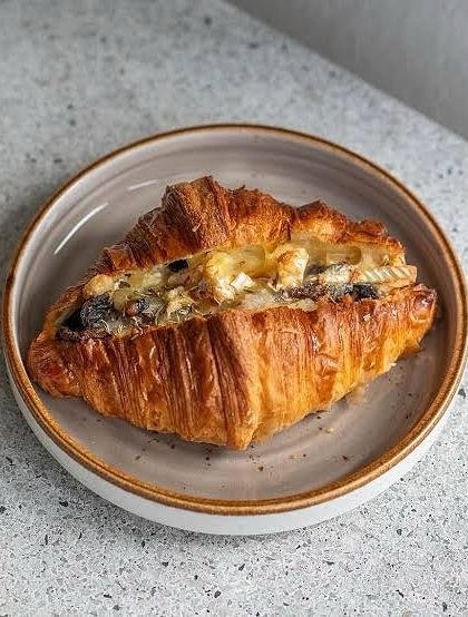 For those who prefer savory, we offer this Cheesy Mushroom Croissant. It's flaky, buttery, and filled with sautéed mushrooms and melted cheese.