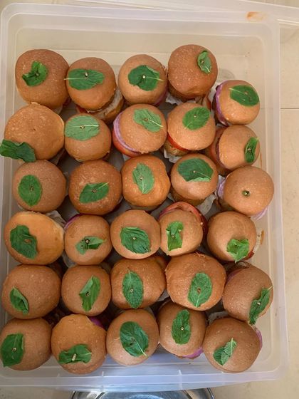 A container full of my popular mini veggie burgers, a favorite among kids and adults for parties and events.