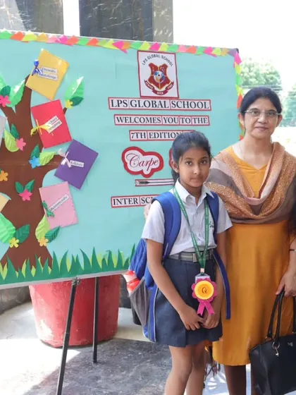 Participants of the Carpe Diem event stand next to a 'Tree of Knowledge' display, symbolizing the growth of ideas.
