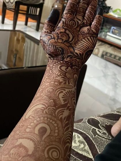 The full-arm stain from the same client. The intricate patterns have developed into a deep, beautiful color all the way up her arm.