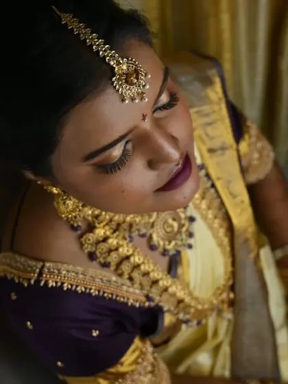 Another artistic angle showcasing the dramatic eye makeup. The winged eyeliner and full lashes are key to making the eyes pop for wedding photos.