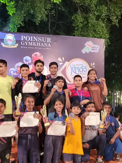 A group of our victorious boxers from various clubs under our training, showcasing their medals and certificates from the Poinsur Gymkhana tournament.