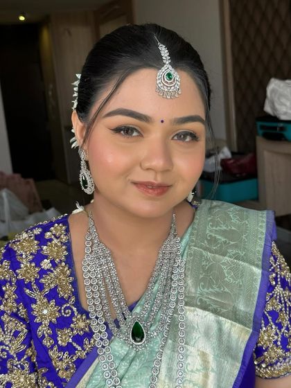 A close-up of the bride's beautiful face. Her makeup is fresh and radiant, with a signature glow that lights up her features.
