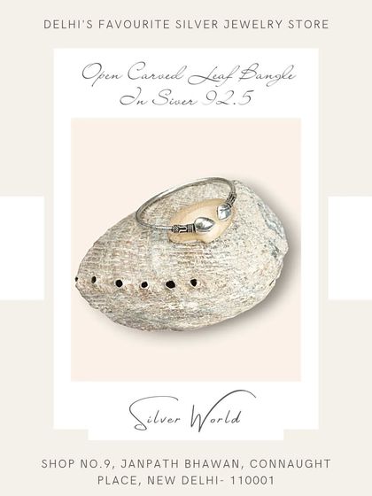 An open carved leaf bangle in pure 92.5 silver. This free-size design is delicate and inspired by nature.