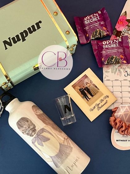 A complete bridesmaid hamper, perfect for asking your best friends to stand by your side. This personalised trunk box includes a custom sipper, polaroid magnet, shot glass, snacks, and self-care items.