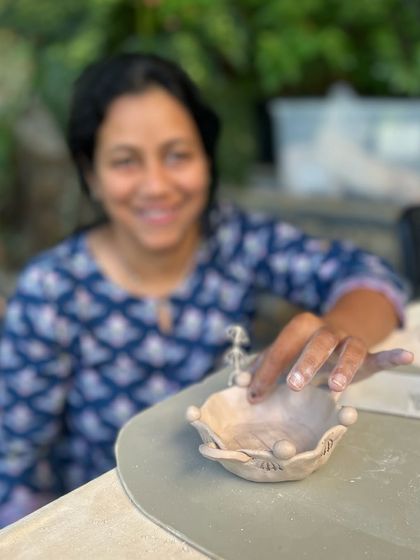 A smile of quiet satisfaction. A participant at the retreat enjoying the process of shaping her nature-inspired bowl.