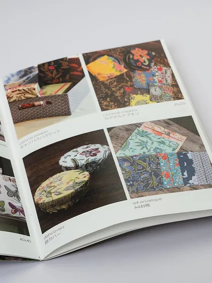 An open product catalog, showcasing the layout and photography within. We also provide photography services for print materials like lookbooks and catalogs.