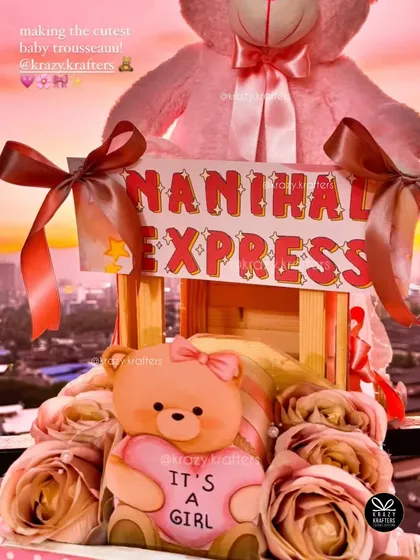 A beautiful shot of the 'Nanihaal Express' trousseau against a sunset backdrop, highlighting the 'It's a Girl' teddy bear.