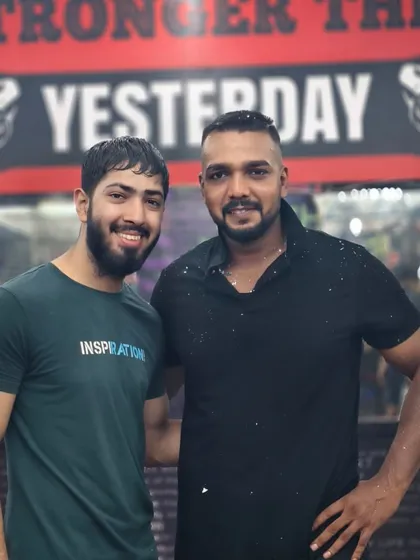 Learn to be happy with your precious time. A photo with a student, celebrating the journey in front of our "Stronger Than Yesterday" wall.