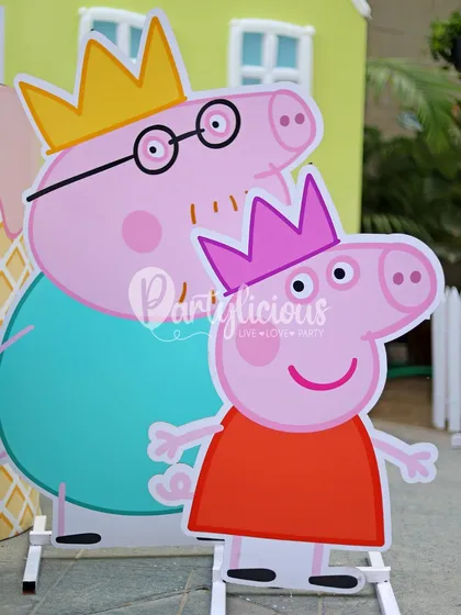 Life-sized cutouts of Peppa and Daddy Pig wearing crowns, perfect for photos and adding to the immersive theme.