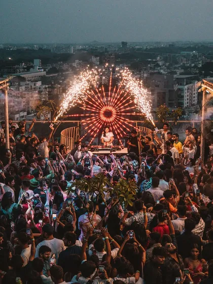 This is the energy I bring to every show. A packed rooftop sundowner in Nagpur with the city lights behind us and pyrotechnics lighting up the sky. This is the kind of high-energy party I love to create.
