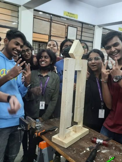 Success. The students celebrate after assembling a large-scale figure using the joinery techniques they just learned.
