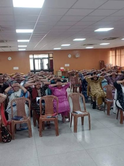 The audience participating in a mindfulness exercise. Mental wellness is just as important as physical fitness.