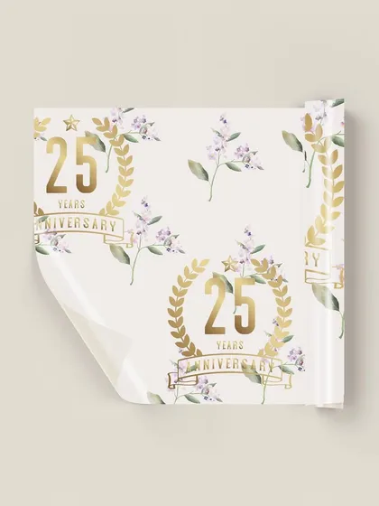 A closer view of the custom 25th anniversary gift wrap. The repeating pattern of the golden anniversary crest and soft lilac florals creates a beautiful and cohesive look for all the event's gifts.