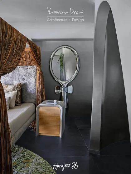The master bedroom's open-concept design includes this artistic dresser area. The 'Lollipop' mirror from Fiam Italia and the custom side table from my Matilda Collection serve as functional sculptures.