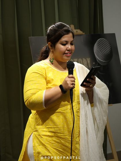 A performer reads her piece with grace and confidence.