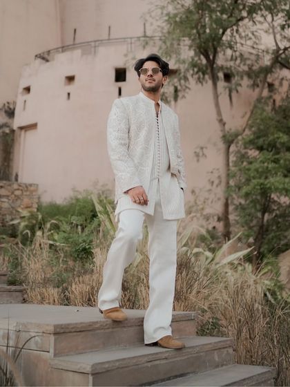 The full look in a natural setting. Dulquer Salmaan's Faraz Manan outfit stands out, showing how traditional craftsmanship can feel completely contemporary.