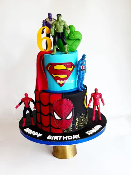 An epic Avengers-themed cake for Kavish's 6th birthday. This design combines multiple superheroes like Superman, Spider-Man, and Hulk into one action-packed, two-tier centerpiece.