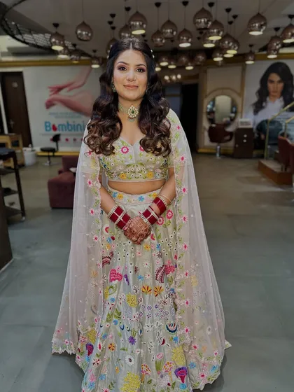 The full outfit, showing how the hair and makeup perfectly complement the colourful, embroidered lehenga.