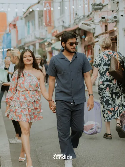 The couple walks hand-in-hand through the charming streets of Phuket Old Town, a great example of incorporating local culture into a pre-wedding shoot.