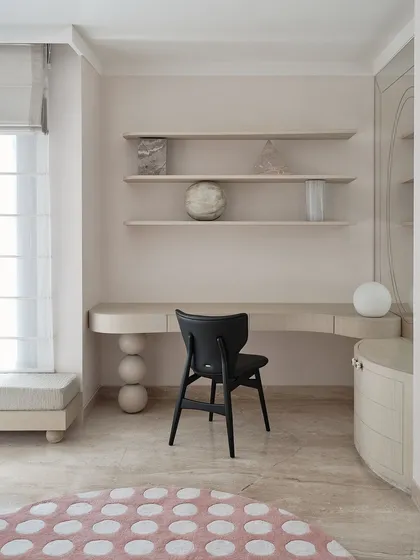 The daughter's room features a study desk with sculptural, spherical legs and a soft, polka-dotted rug. The design is playful and modern, with a palette of soft, muted tones.