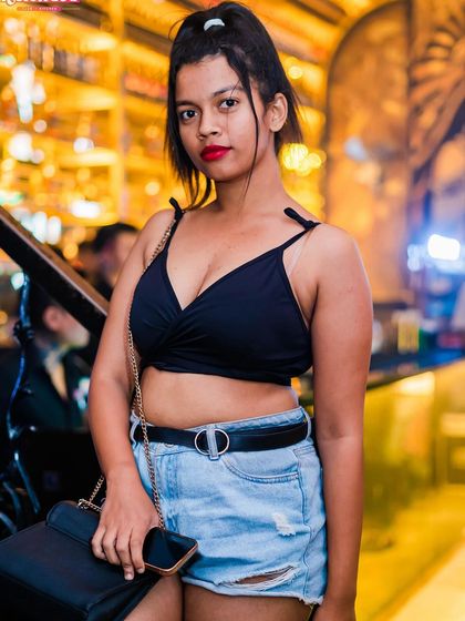 A guest posing in a crop top and shorts.
